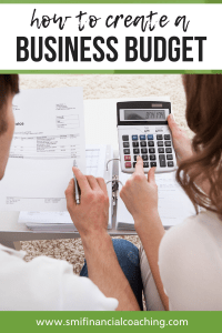 Man and woman using a calculator and stack of bills to create a business budget