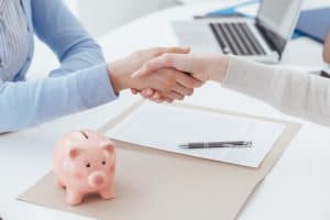 Financial planner shaking hands with new client